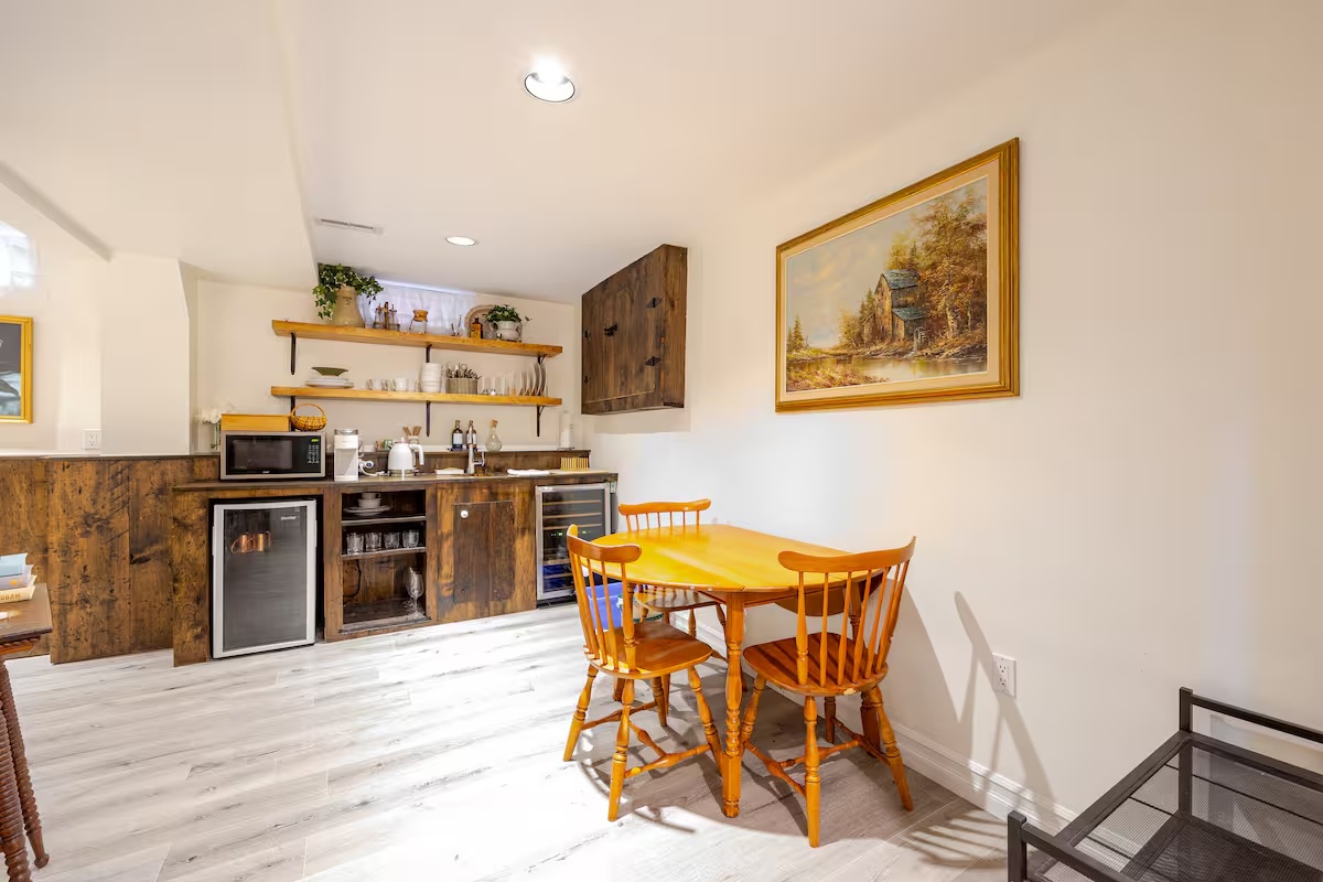 Dining nook and kitchenette with warm wood cabinets, table, and chairs